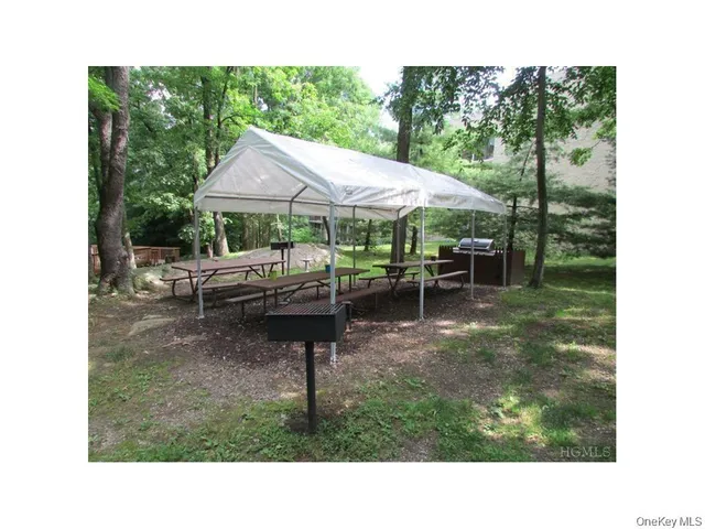 a swimming pool with outdoor seating and yard