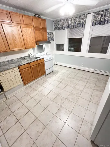 a kitchen with stainless steel appliances a stove a sink and a microwave