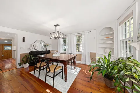 a view of a dining room with furniture window and wooden floor