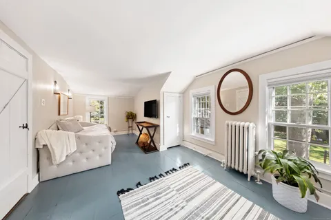 a bedroom with furniture and a window