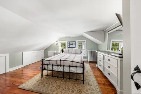 a spacious bedroom with a bed and a large window