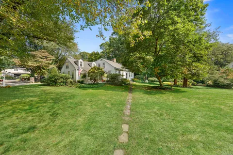 a view of yard with swimming pool and green space
