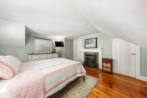 a spacious bedroom with a bed and a fireplace