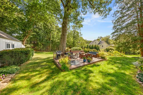 a view of yard with swimming pool and green space