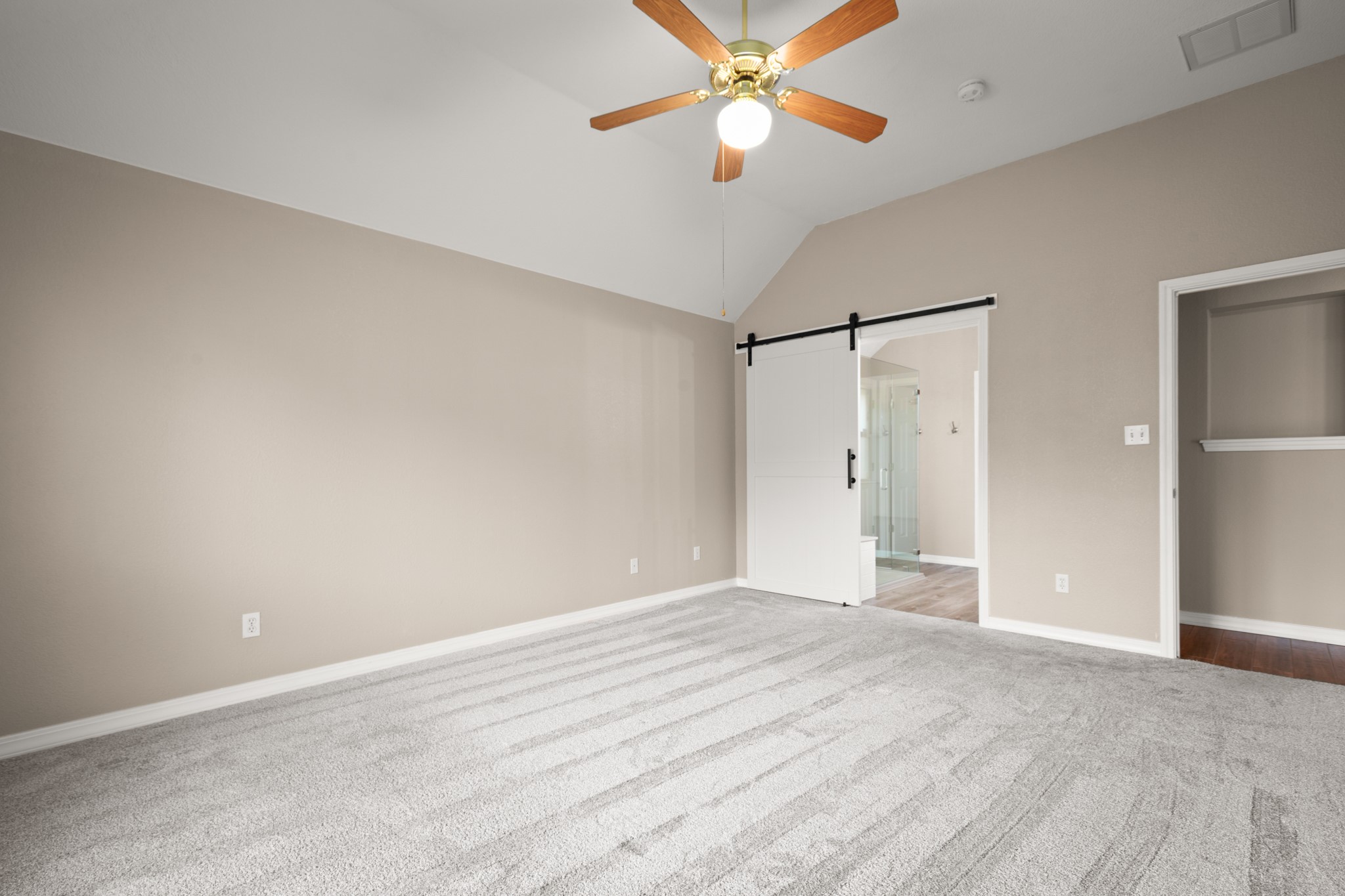 3420 Ribbon Reef Lane Austin, TX 78728 - Photo 13 of 25 Primary bedroom with barn door to primary bath