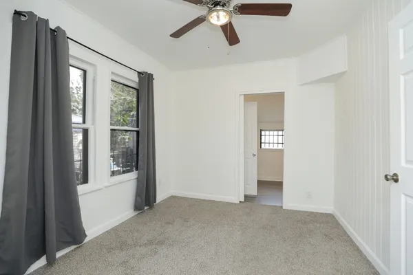 a view of a livingroom with a ceiling fan and window