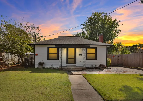 a view of swimming pool with outdoor seating and house in the background