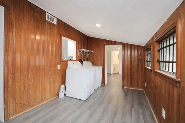a view of a hallway with washer and dryer