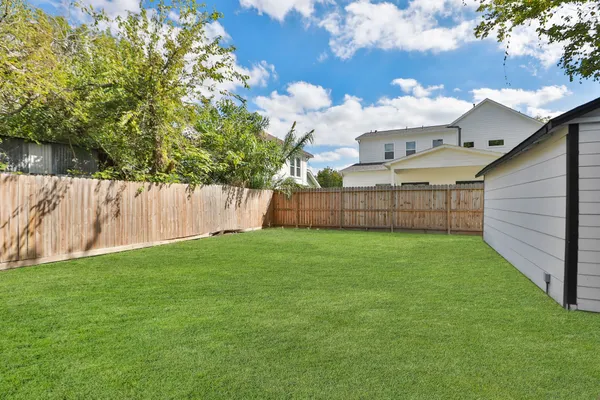 a view of a backyard with a garden and entertaining space