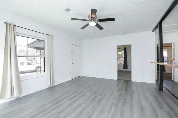 wooden floor in an empty room with a window