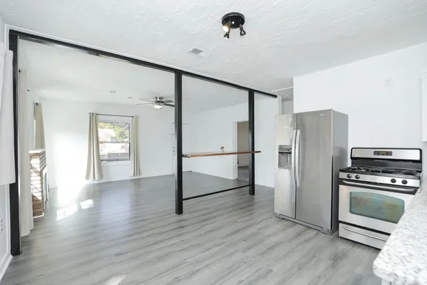 a view of a kitchen with a refrigerator and a stove