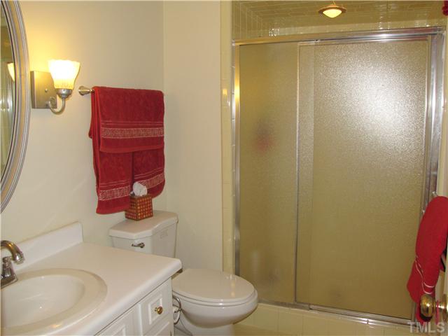 103 Dabney Road Cary, NC 27511 - Photo 13 of 25 a bathroom with a sink a toilet and shower