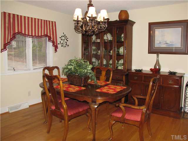 103 Dabney Road Cary, NC 27511 - Photo 5 of 25 a view of a dining room with furniture and chandelier