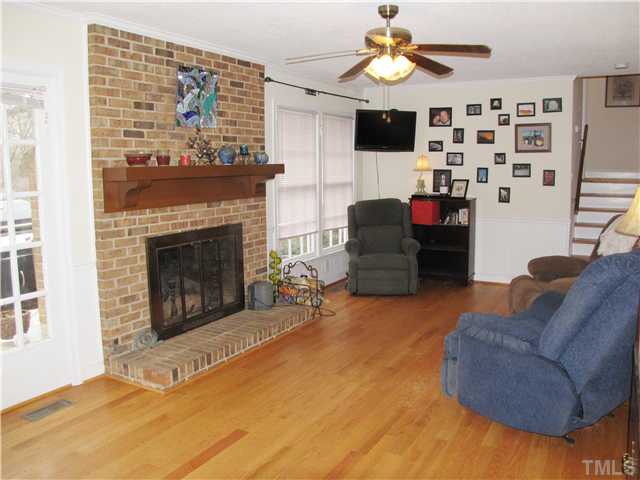 103 Dabney Road Cary, NC 27511 - Photo 7 of 25 a living room with furniture and a fireplace