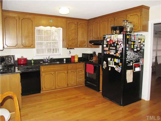 103 Dabney Road Cary, NC 27511 - Photo 9 of 25 a kitchen with stainless steel appliances granite countertop a stove a sink and a refrigerator