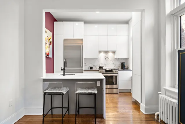 a kitchen with stainless steel appliances granite countertop a stove a sink and a refrigerator