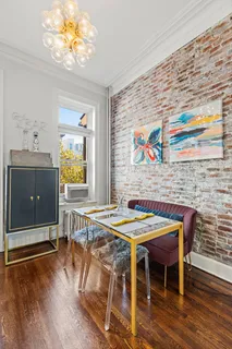 a dining room with furniture and wooden floor
