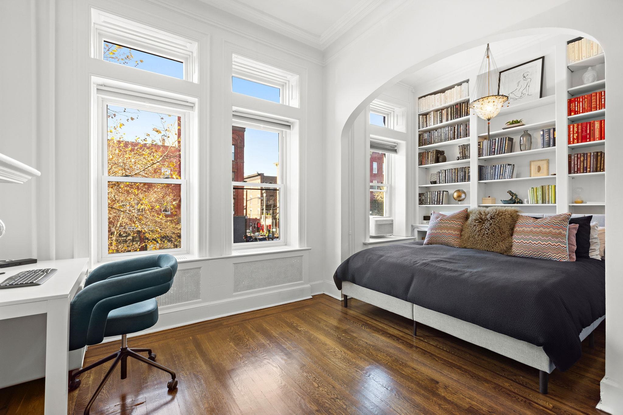 937 Washington Street, Unit 2 Hoboken, NJ 07030 - Photo 5 of 21 a bedroom with a bed lamp and a large window