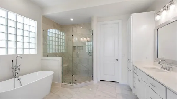 a bathroom with a granite countertop sink a toilet a mirror and shower