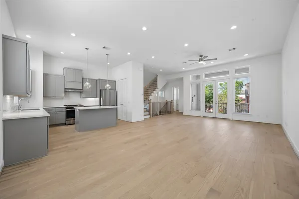 a view of kitchen with kitchen island and stainless steel appliances