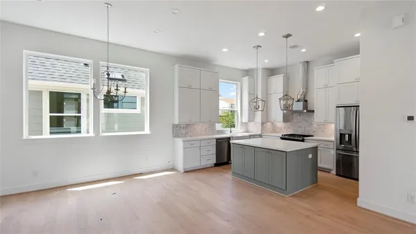 a kitchen with a stove a sink and a refrigerator