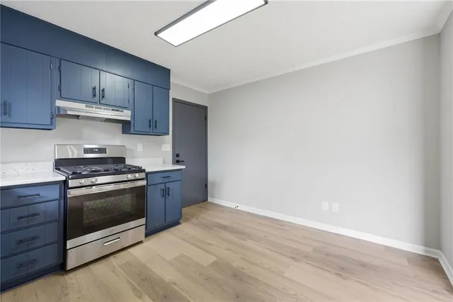 a kitchen with granite countertop a stove and a sink