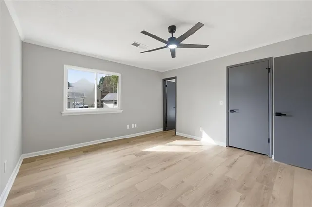 a view of a big room with wooden floor and windows in a room