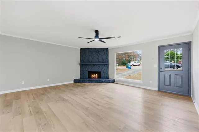 wooden floor in an empty room with a fireplace