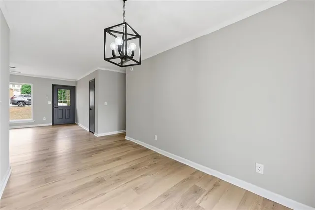 a view of a room with wooden floor closet and windows