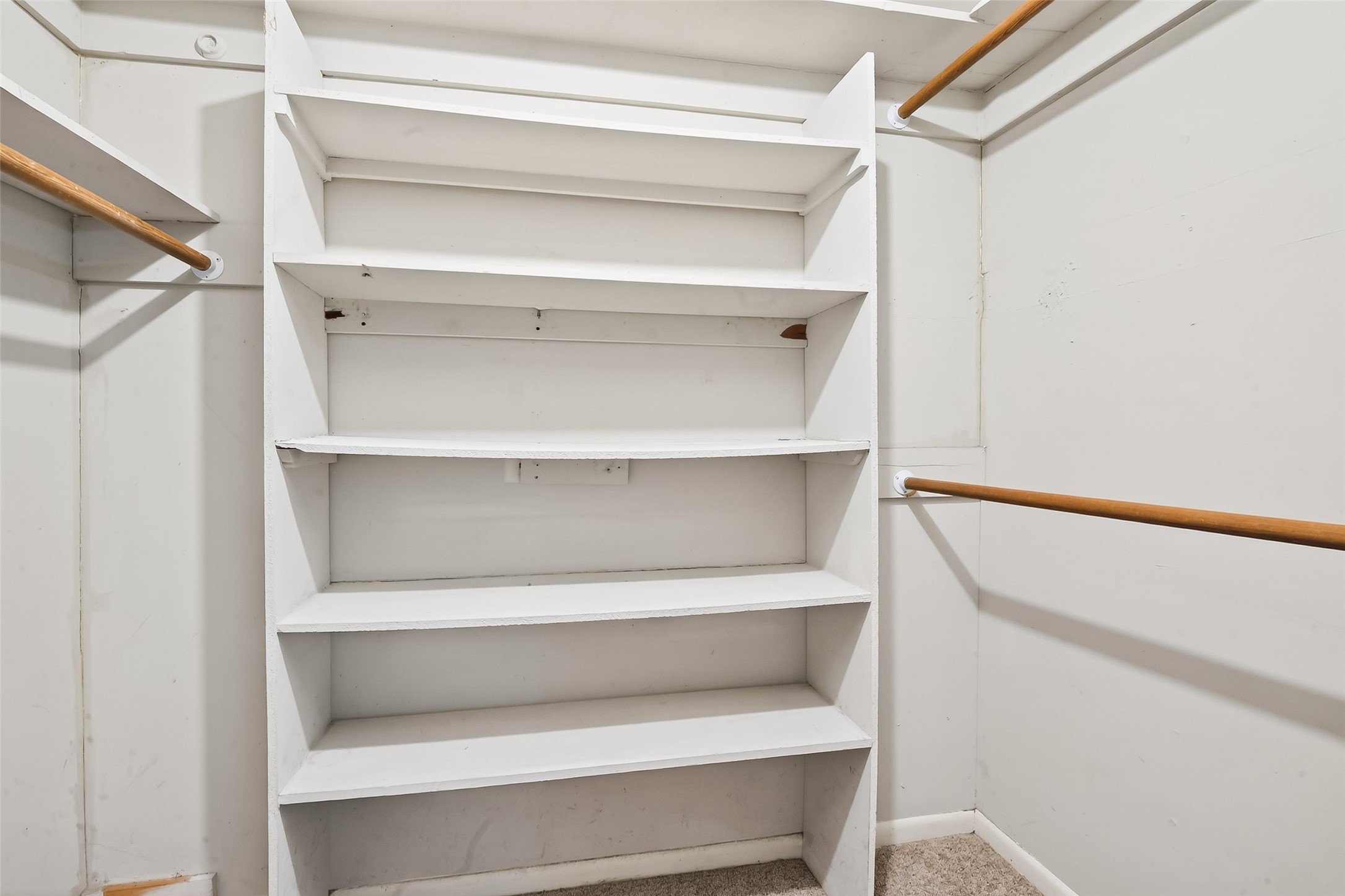 5422 Spellman Road Houston, TX 77096 - Photo 14 of 27 a view of walk in closet with empty racks