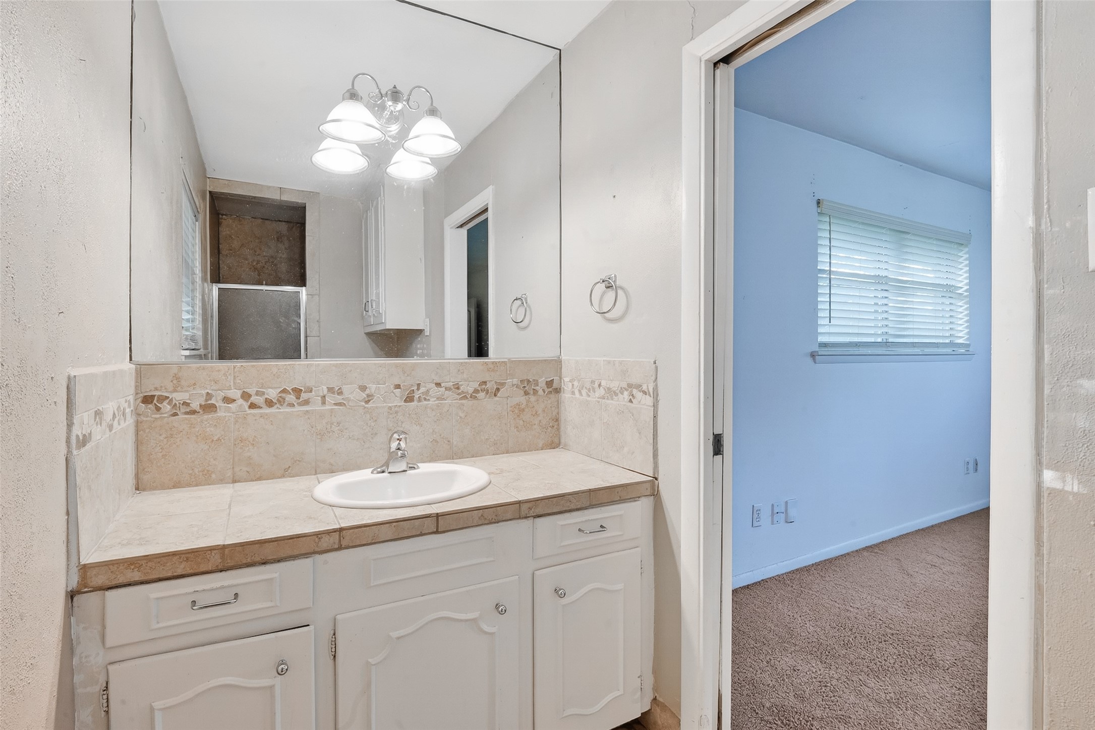 5422 Spellman Road Houston, TX 77096 - Photo 15 of 27 a bathroom with a sink vanity and mirror