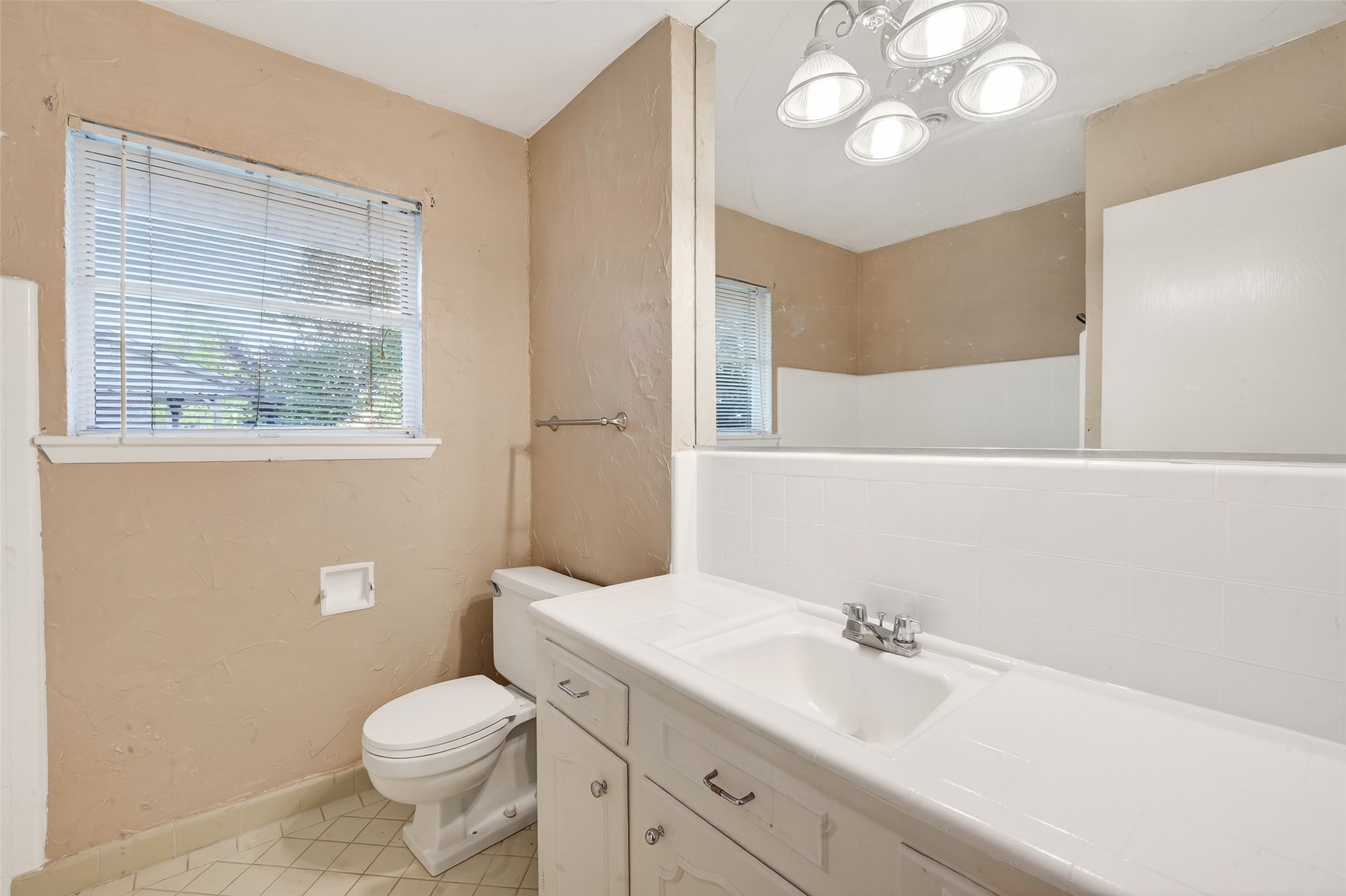 5422 Spellman Road Houston, TX 77096 - Photo 19 of 27 a bathroom with a sink a toilet and a mirror