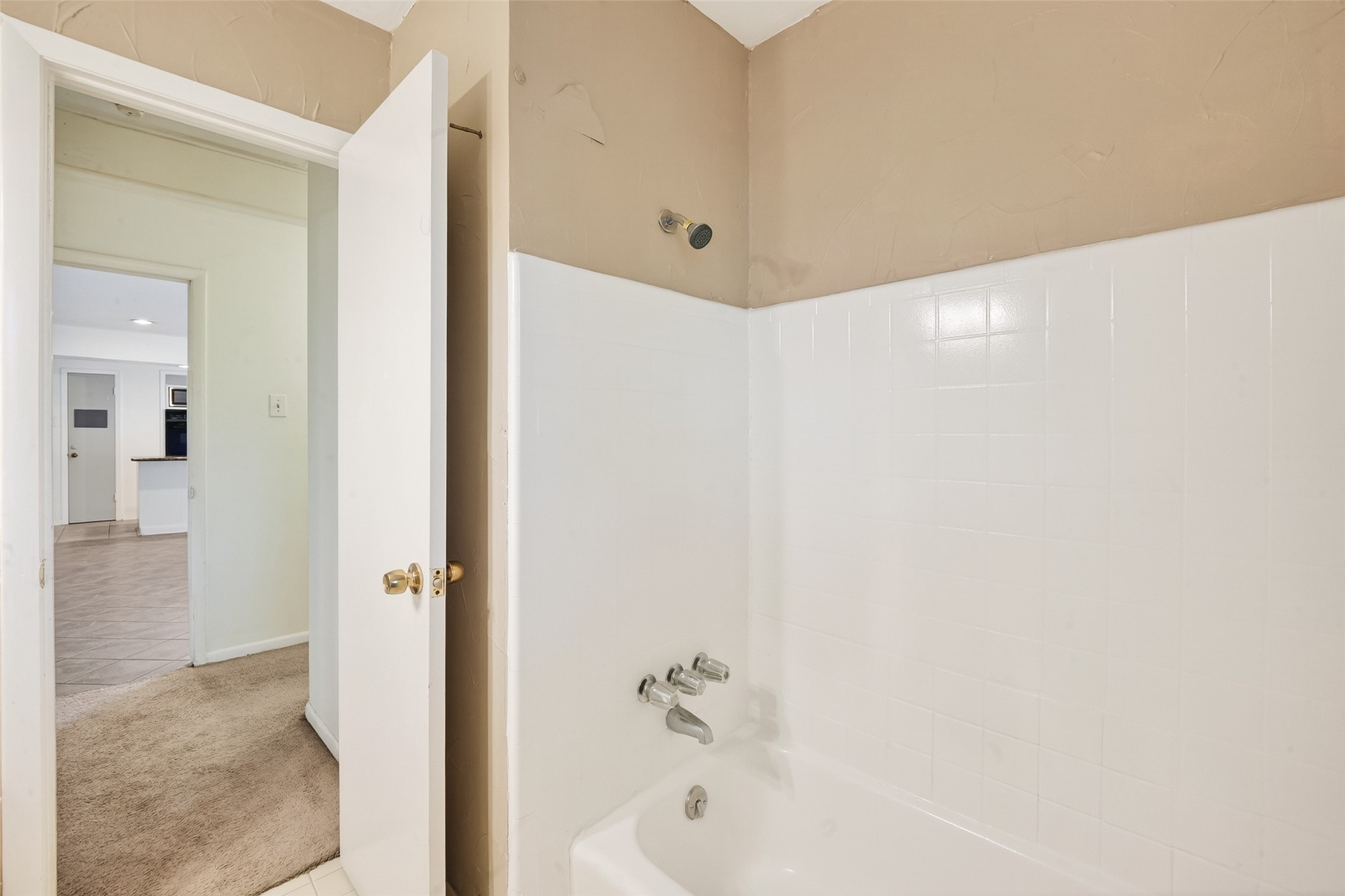 5422 Spellman Road Houston, TX 77096 - Photo 20 of 27 a bathroom with a bathtub and a shower
