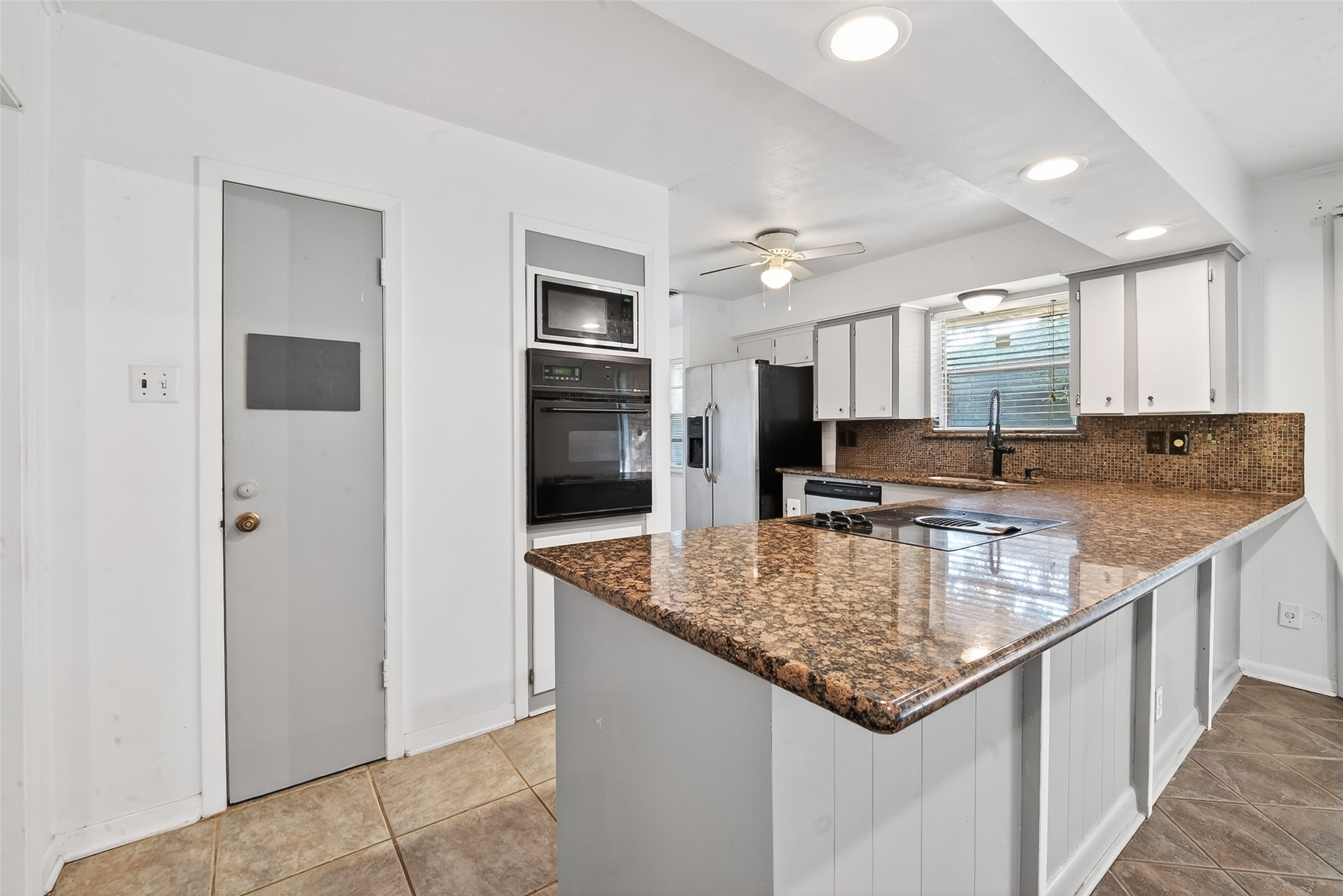 5422 Spellman Road Houston, TX 77096 - Photo 8 of 27 a kitchen with stainless steel appliances granite countertop a sink stove and refrigerator