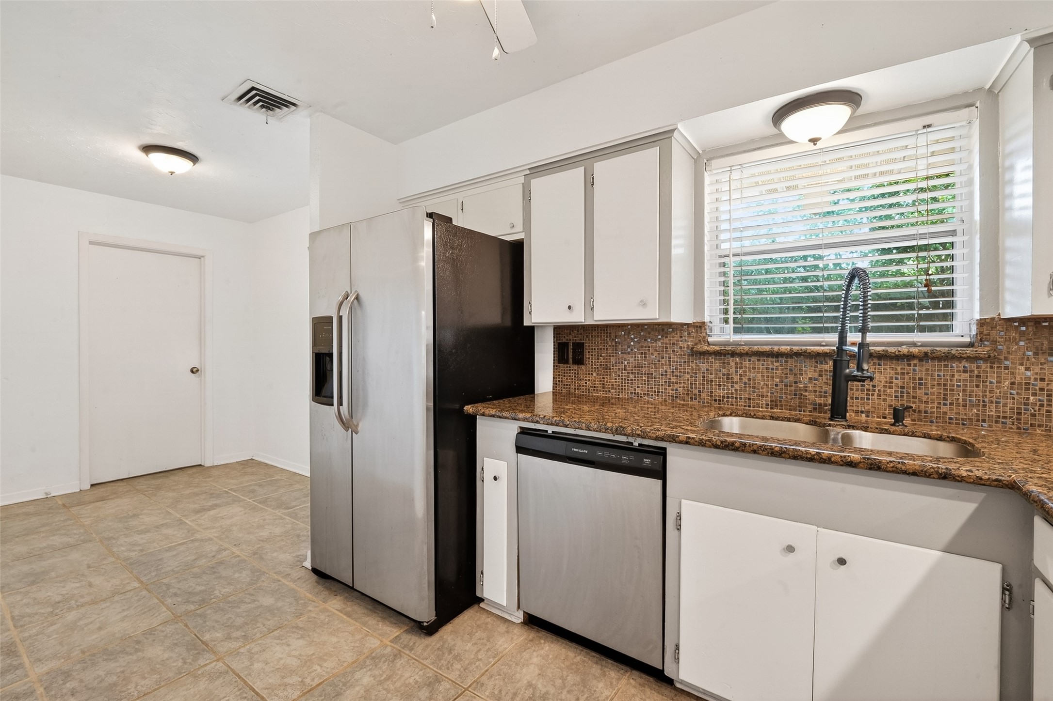 5422 Spellman Road Houston, TX 77096 - Photo 9 of 27 a kitchen with stainless steel appliances granite countertop a refrigerator and a sink
