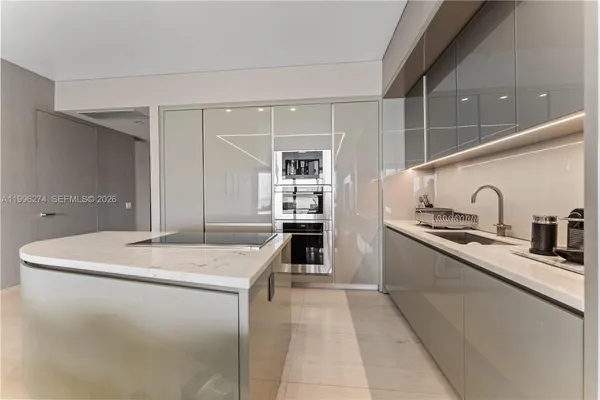 a kitchen with stainless steel appliances granite countertop a sink a stove and a refrigerator