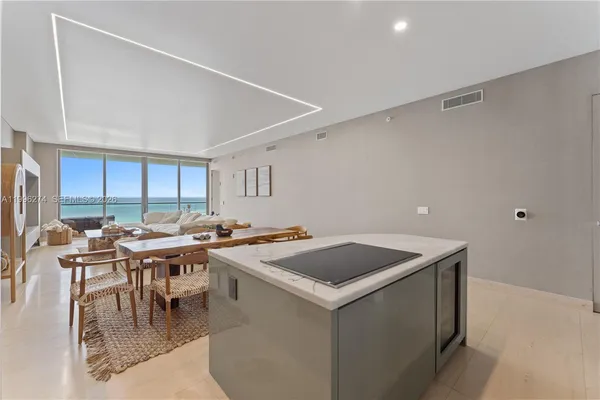 a kitchen with a stove a table and chairs