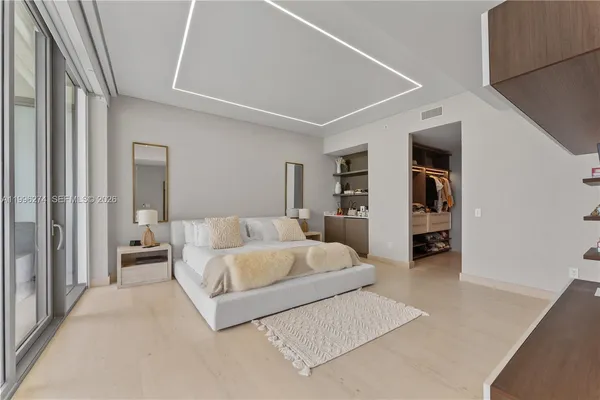 a spacious bedroom with a large bed and a walk in closet