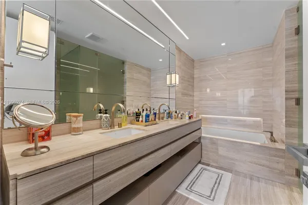 a bathroom with a double vanity sink and a mirror