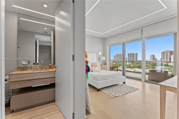 a bedroom with a bed and large window