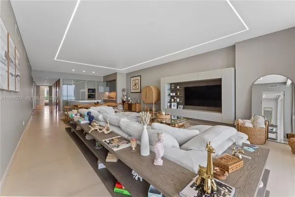 a living room with furniture wooden floor and a flat screen tv