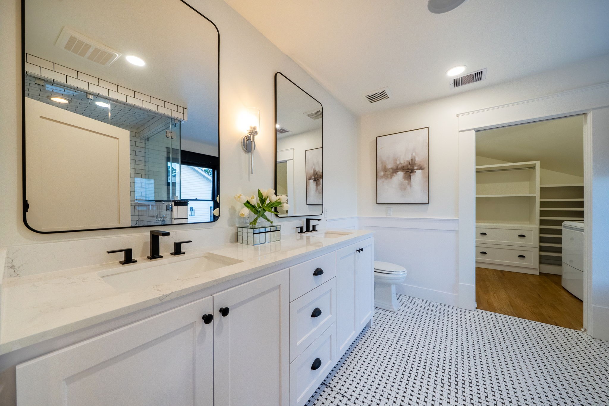 1109 Rutland Street Houston, TX 77008 - Photo 18 of 34 Step into a sanctuary of style and functionality in this stunning primary bathroom. The newly installed dual sink vanity offers both elegance and practicality, complemented by a sleek, contemporary mirror that amplifies the space. Thoughtfully upgraded lighting sets the perfect ambiance, whether you're starting your day or winding down. A space designed to elevate your daily routine—luxury and comfort seamlessly combined.