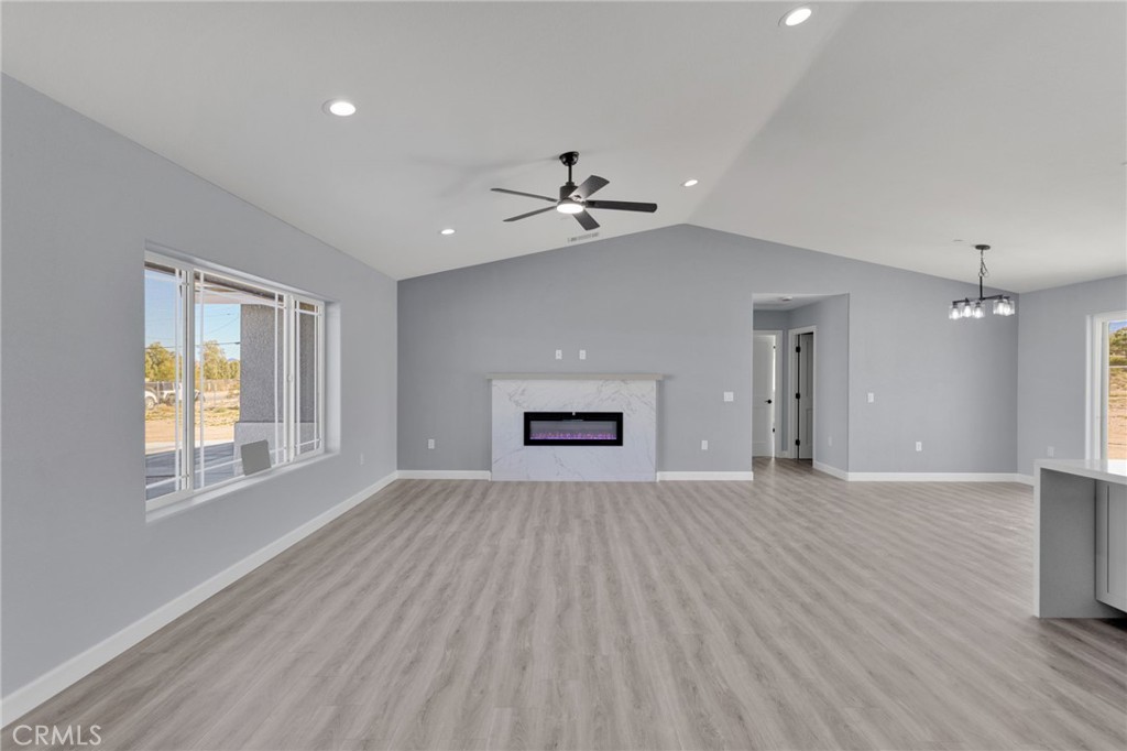 36165 Sutter Road Lucerne Valley, CA 92356 - Photo 2 of 42 an empty room with windows and ceiling fan