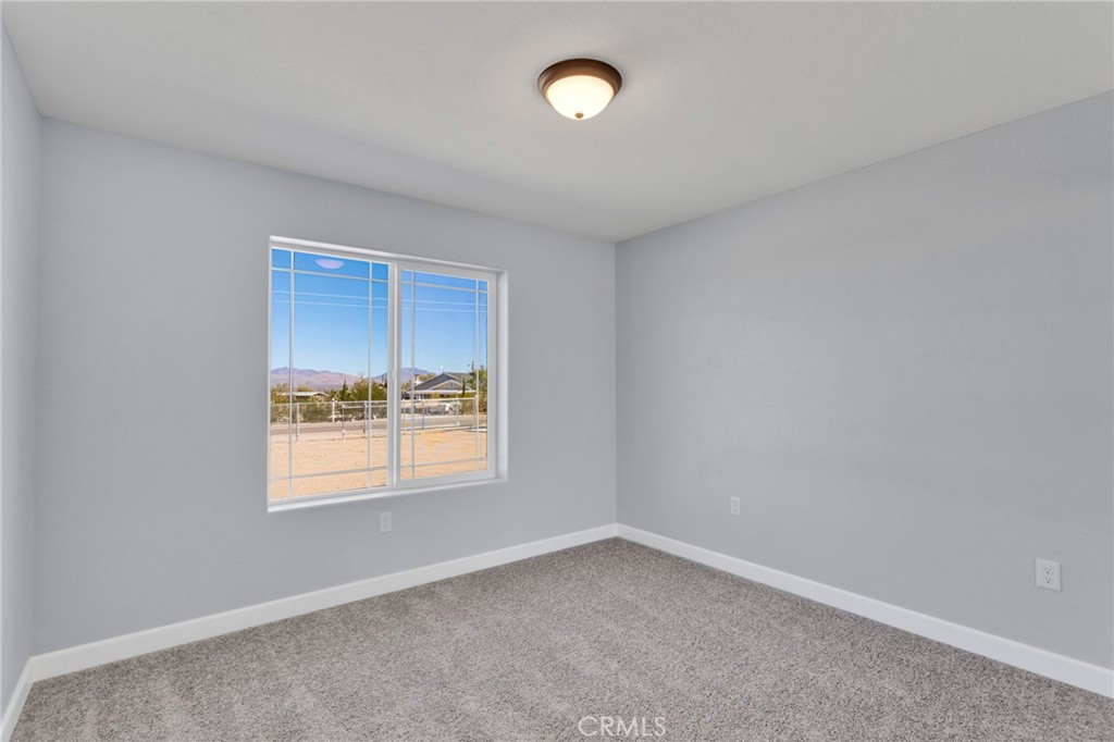 36165 Sutter Road Lucerne Valley, CA 92356 - Photo 21 of 42 an empty room with a window