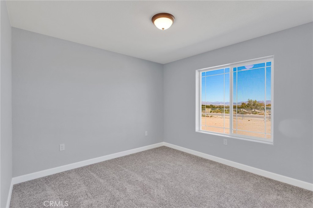 36165 Sutter Road Lucerne Valley, CA 92356 - Photo 23 of 42 an empty room with windows