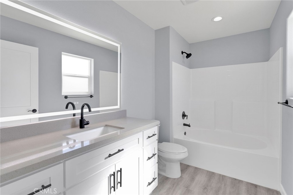 36165 Sutter Road Lucerne Valley, CA 92356 - Photo 27 of 42 a bathroom with a granite countertop sink a toilet and a bathtub