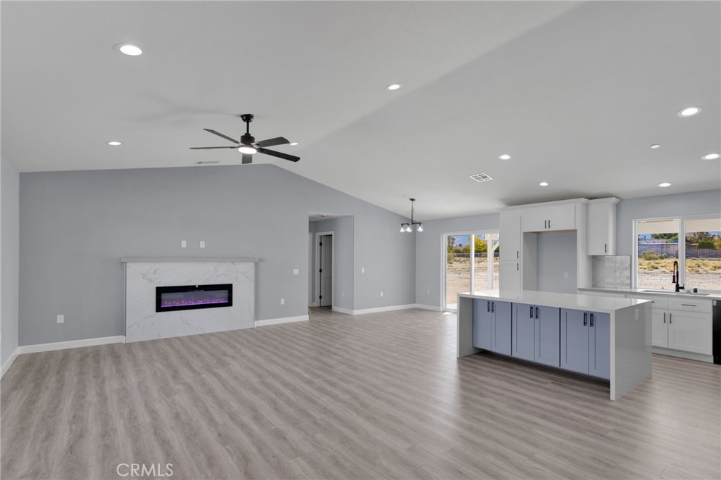 36165 Sutter Road Lucerne Valley, CA 92356 - Photo 6 of 42 a view of a kitchen with wooden floor and a ceiling fan