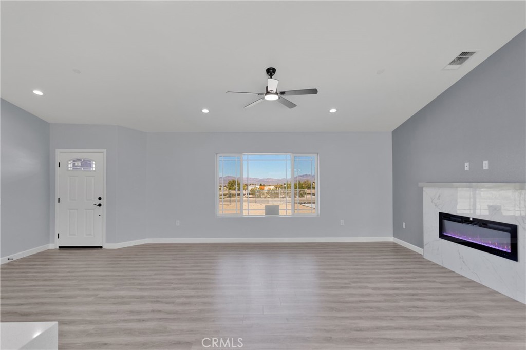 36165 Sutter Road Lucerne Valley, CA 92356 - Photo 7 of 42 a view of an empty room with a window and a kitchen