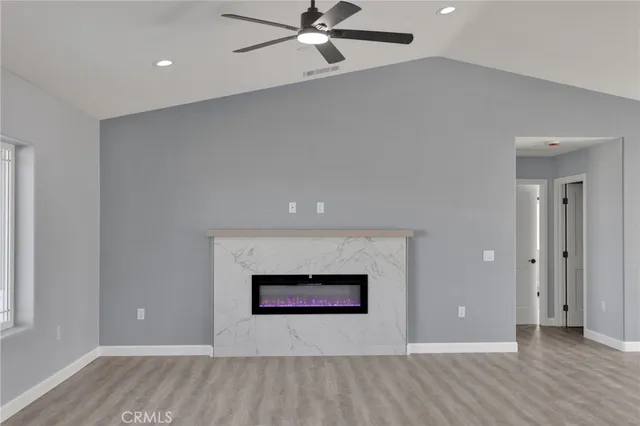 wooden floor in an empty room with a fireplace