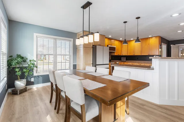 a dining room filled with furniture and window